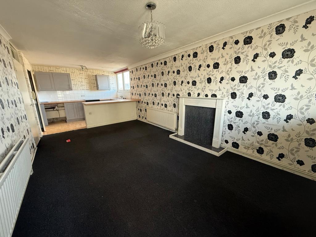 Lot: 137 - TWO-BEDROOM FLAT FOR IMPROVEMENT - Living room looking towards kitchen
